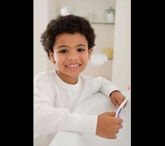 happy kid brushing his teeth image