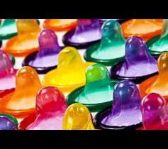 A row of rainbow colored condoms reminds us to use a condom, every time, to prevent sexually trasmitted diseases (STDs) or infections (STIs)