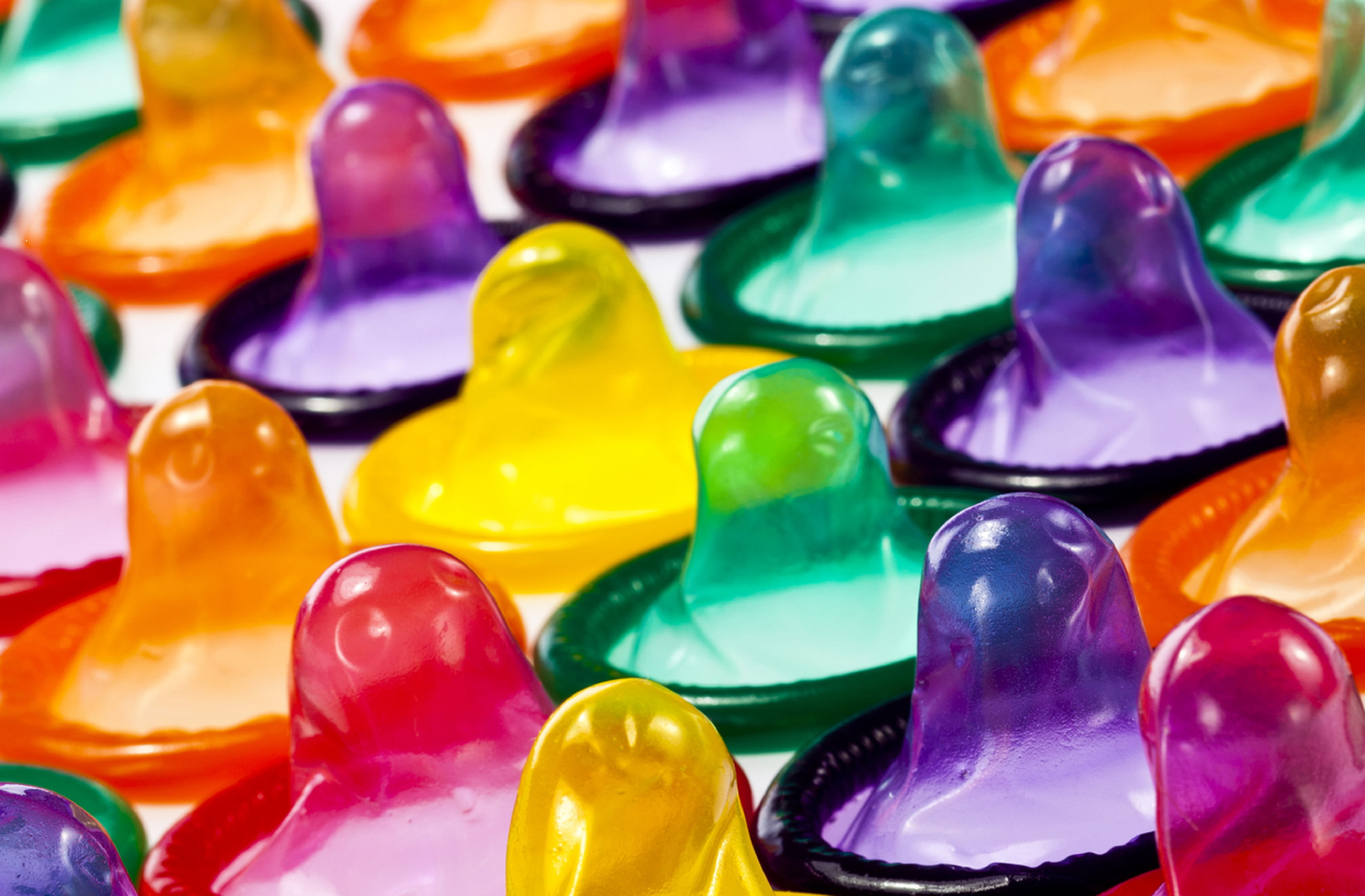 A row of rainbow colored condoms reminds us to use a condom, every time, to prevent sexually trasmitted diseases (STDs) or infections (STIs)