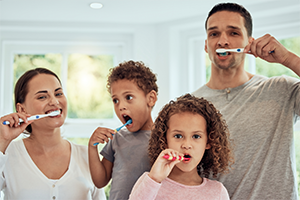 Family brushing their teeth